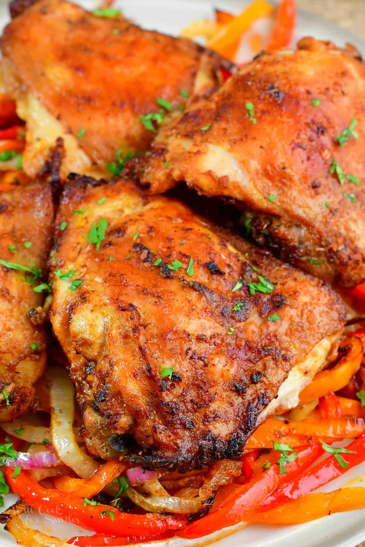 closeup of cooked chicken thighs with peppers