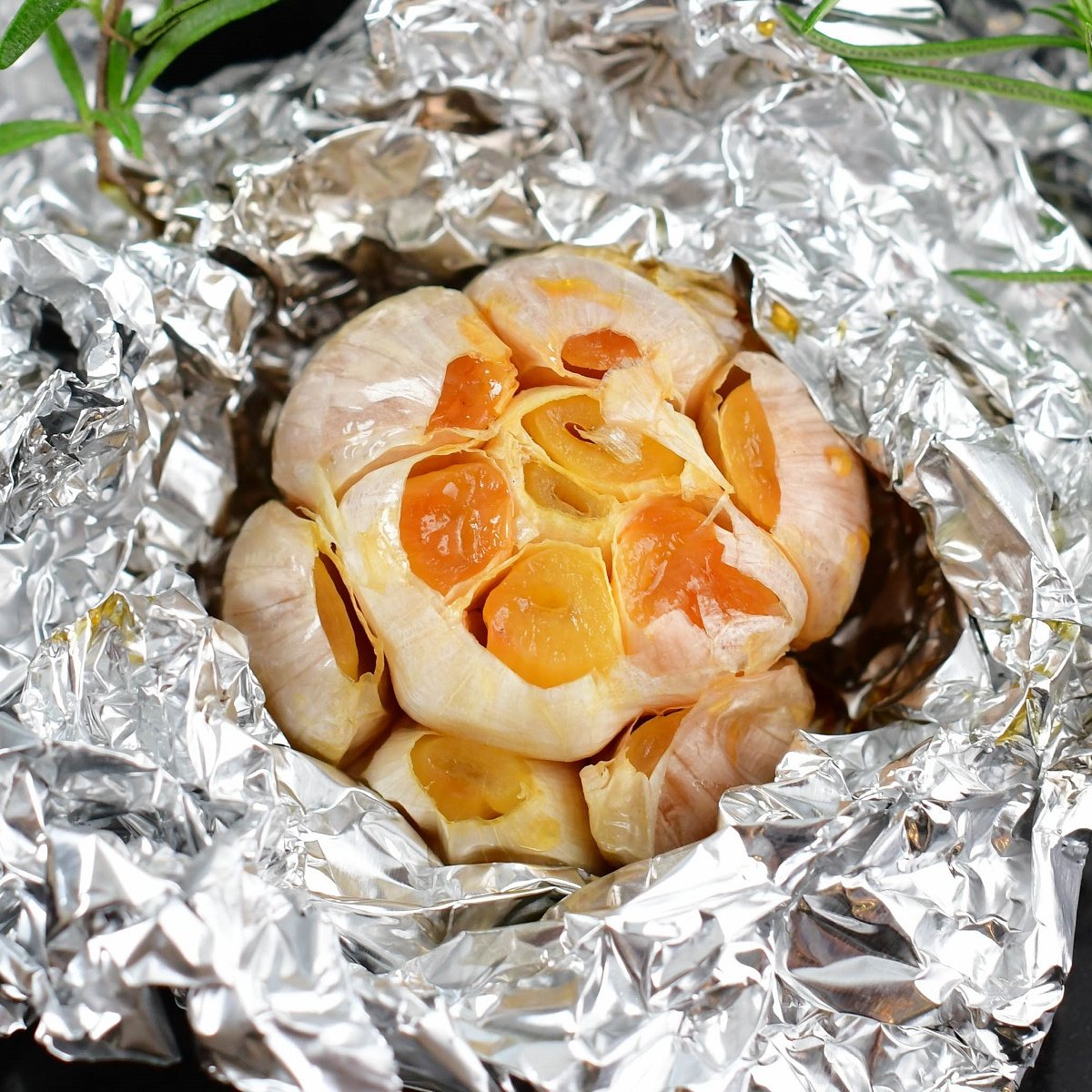 squared off image of roasted garlic in foil